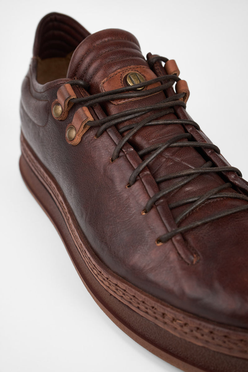 COLE cognac welted distressed loop sneakers.