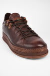 COLE cognac welted distressed loop sneakers.