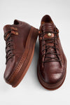 COLE cognac welted distressed loop sneakers.