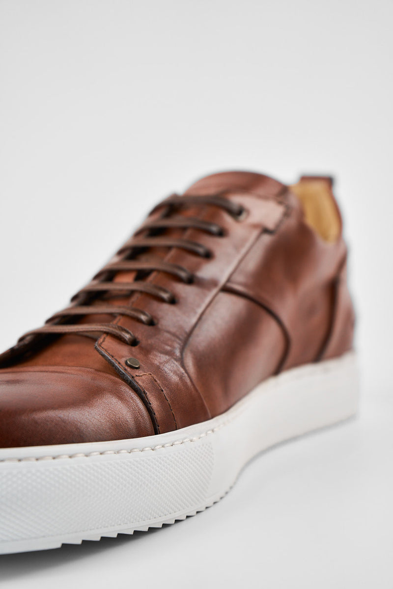 SKYE cognac studded patina sneakers.