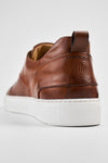 SKYE cognac studded patina sneakers.