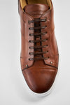 SKYE cognac studded patina sneakers.