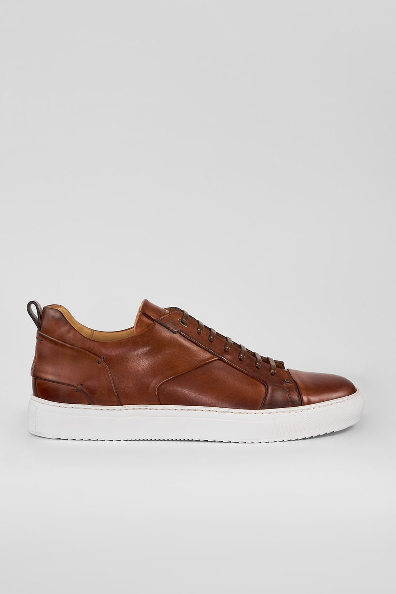 SKYE cognac studded patina sneakers.