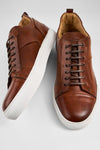 SKYE cognac studded patina sneakers.